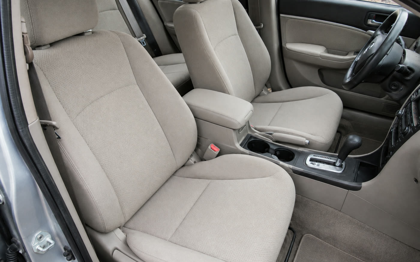 The same seats and console from the same position, the cloth back to an even cream and the console clean