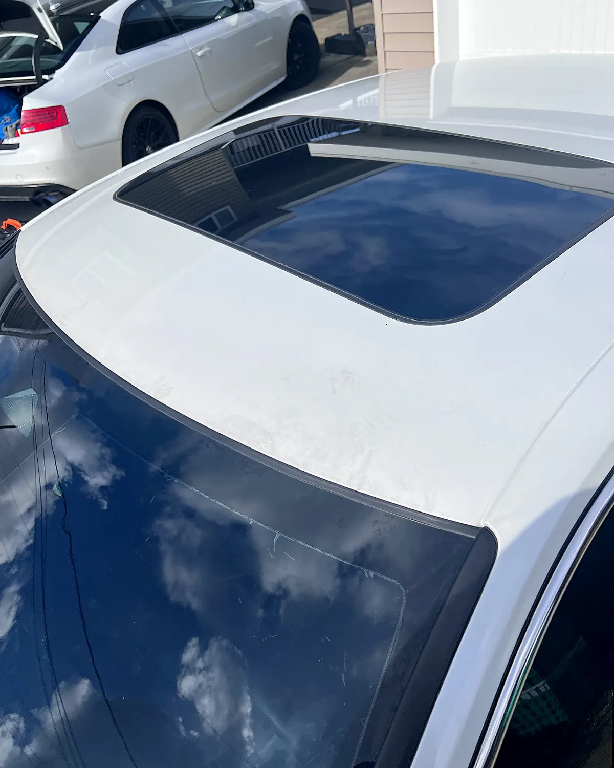 The same roof and sunroof from the same position, the staining gone and the white paint even