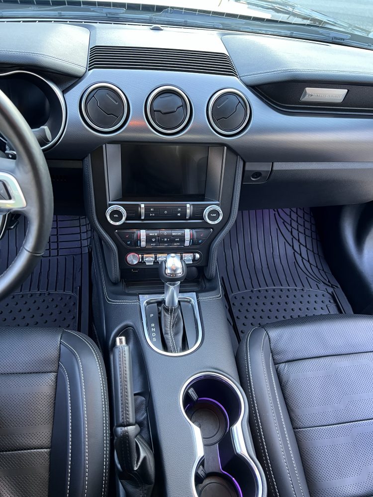 A Ford Mustang interior after cleaning — dash, centre console and floor mats