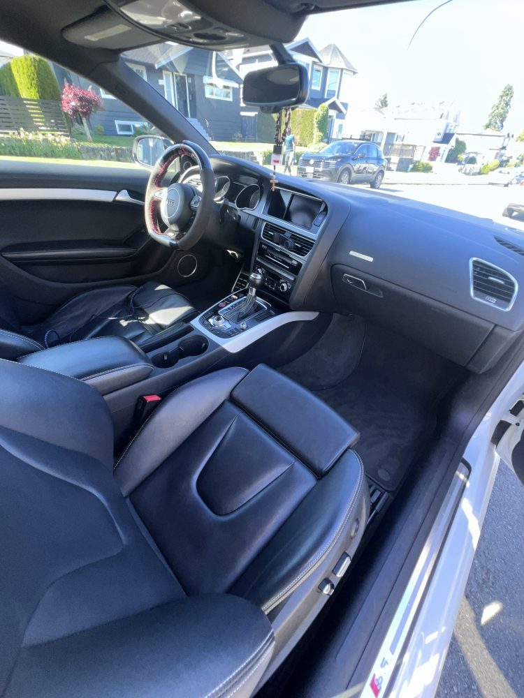 An Audi dashboard and passenger side after an interior detail